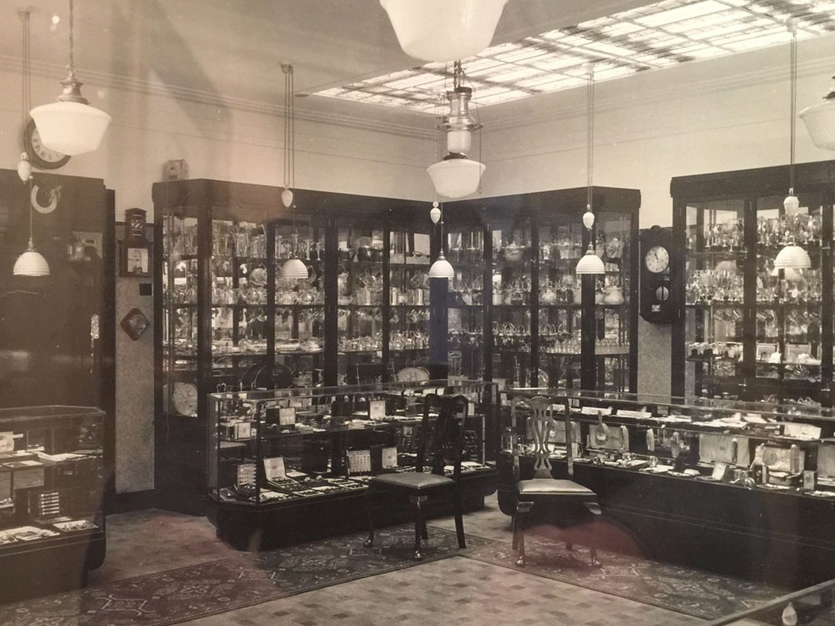 The Picketts and Pursers showroom, mahogany and glass cabinets under pendant lamps, likened to stepping back in time